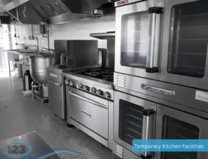 Commercial mobile kitchen with ovens, gas ranges, and stainless steel appliances for large-scale meal production.