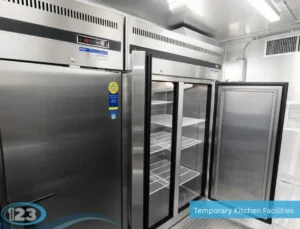 Stainless steel commercial reach-in refrigerators providing refrigerated food storage inside a mobile kitchen trailer.