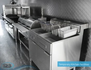 Stainless steel commercial deep fryer station inside a mobile kitchen trailer for high-volume food preparation.